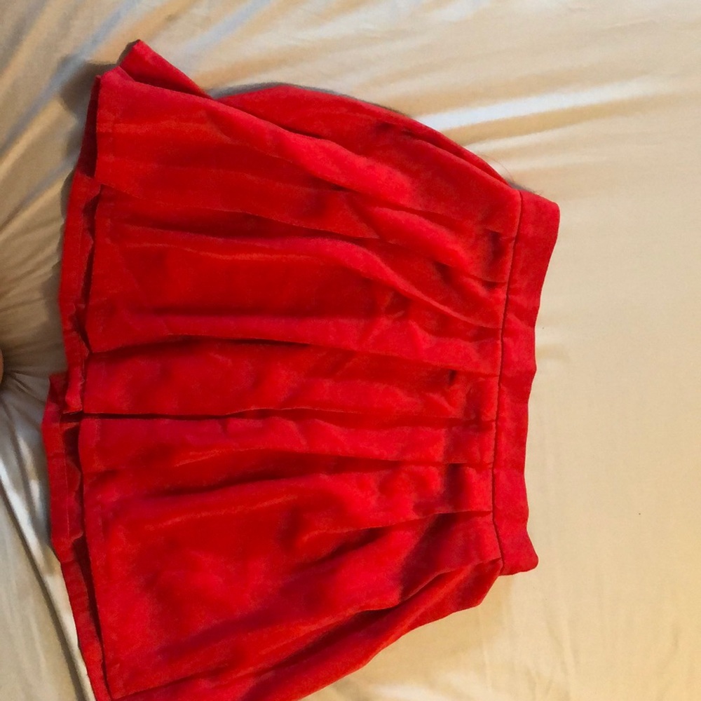 Short pleated red skirt